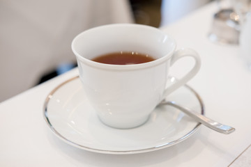 White cup of tea on the table, Soft focus