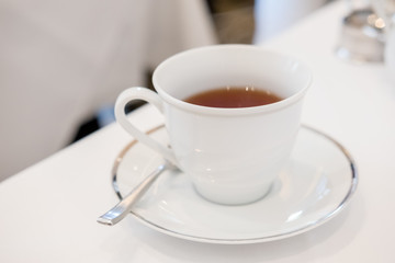White cup of tea on the table, Soft focus