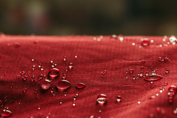 Rain Water droplets on  red waterproof fabric