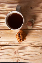 Cup of Tea with Cookies on wooden background. top view
