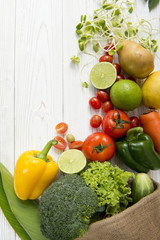 Fresh organic vegetables Include lime, tomato, avocado, sweet pepper, broccoli, potatoes on white wooden and copy space. Top view food healthy concept