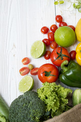 Fresh organic vegetables Include lime, tomato, avocado, sweet pepper, broccoli, potatoes on white wooden and copy space. Top view food healthy concept