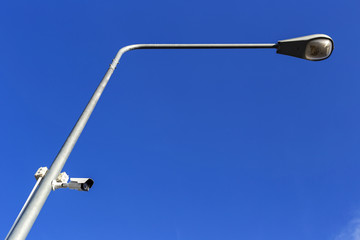 The security camera stuck on light poles for security in the communities.Perspective view under lamp.