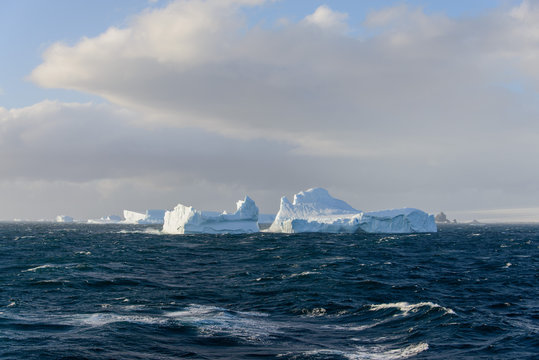 Iceberg in wavy sea
