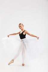 Cheerful young woman ballerina dancing