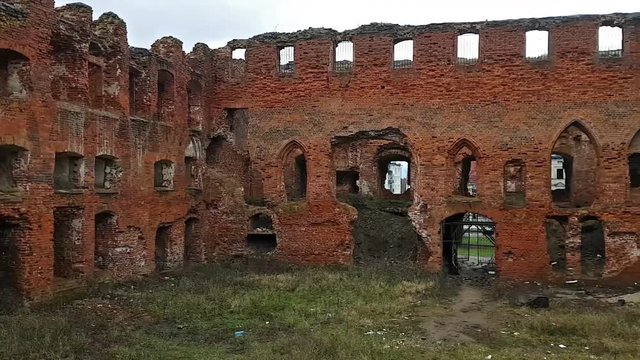 Ruins of medieval fortress Ragnit in town Neman, Kaliningrad oblast. Ancient red brick castle, legacy of German Empire in Russia. Former territory of East Prussia. Historical tourist attraction