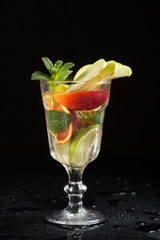 glass with iced vodka on black background