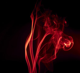 Red smoke on black background