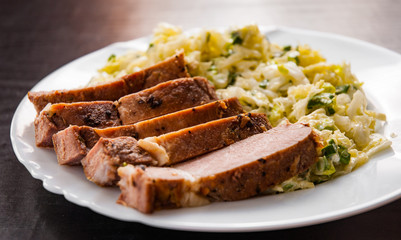 meat fillet with vegetables salad in a plate on wooden table