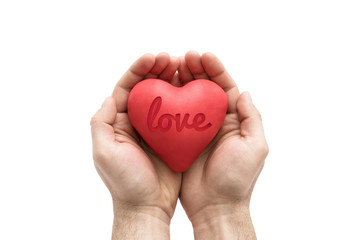 Red heart with imprinted love word in man's hands.