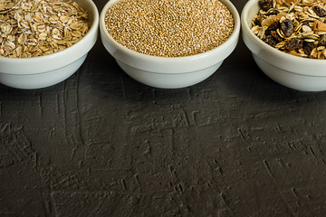 Healthy quinoa cereals, brown rice and oatmeal in a bowl. Concept of healthy carbohydrates.