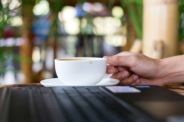 Human hands of a business working whit coffee cup