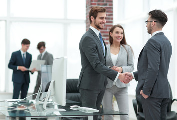 handshake business partners at a meeting