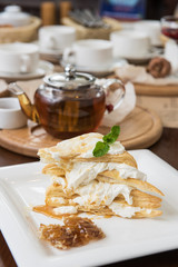 Honey cake with vanilla cream at white plate