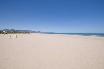 landscape Beach of PIne or Pinar, in Grao of Castellon, Valencia, Spain, Europe. Blue clear sky, Mediterranean Sea and Benicassim in the horizon
