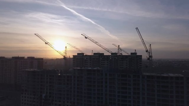 Aerial view of modern city construction and development at sunset