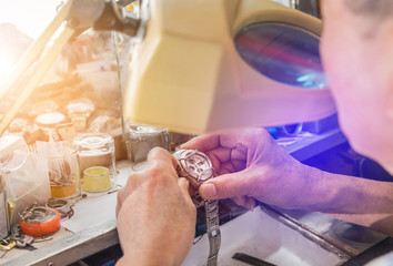 close up watchmaker repairing mechanism old watch 