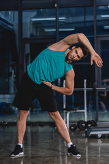 Fototapeta premium athletic man stretching in sports hall