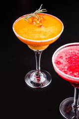 two classic and strawberry margarita, white and red alcoholic cocktail with decoration of salt on the edge of the glass with fresh lime, lemon, daiquiri on gray background restaurant. Bar alcohol menu