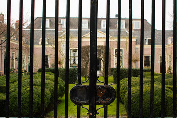Old Beautiful Botanic Garden In Haarlem Netherlands With an Old Rust Gate In Front Of All The Green