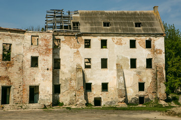 Ruins of the old Klevan castle. Ruined wall with windows against the blue sky. Courtyard. Rivne region. Ukraine