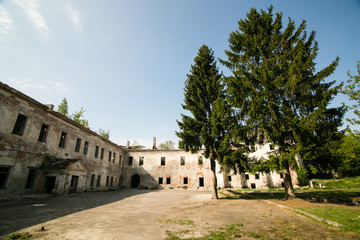 Fototapeta premium Ruins of the old Klevan castle. Ruined wall with windows against the blue sky. Courtyard. Rivne region. Ukraine