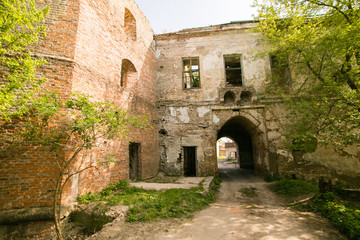 Ruins of the old Klevan castle. Ruined wall with windows against the blue sky. Courtyard. Rivne region. Ukraine
