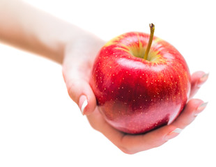 Woman hand giving red apple isolated on whine