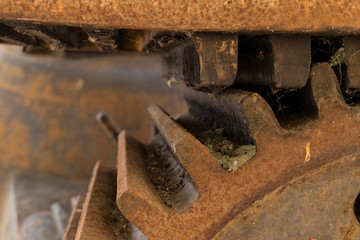 Abandoned water mill gear. Rusty iron wheel with teeth natural background