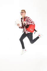 Full length portrait of a joyful schoolboy in eyeglasses