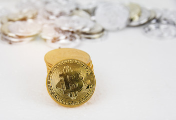 In selective focus of golden bitcoin put on background,in front of blurred silver bitcoin,blurry light design background.
