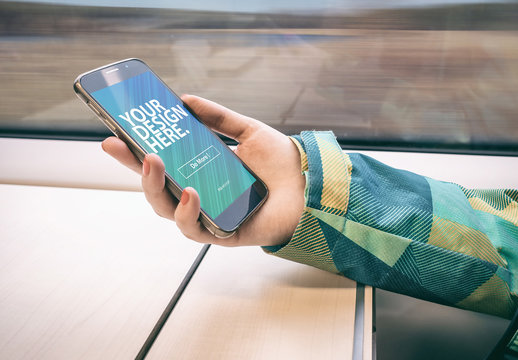 User Holding Smartphone on Moving Train Mockup