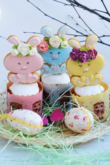 Easter cakes and gingerbread rabbits on white background 