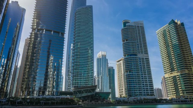 Timelapse view on skyscrapers at waterfront, residential buildings in Jumeirah Lake Towers, Dubai, UAE.