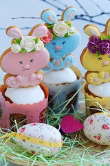 Easter cakes and gingerbread rabbits on white background 