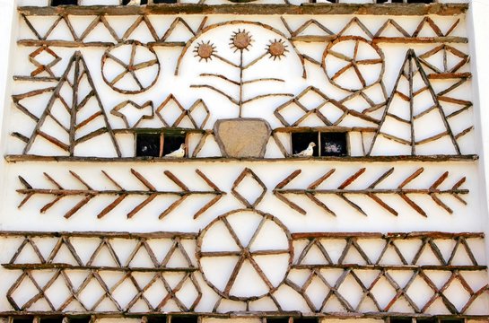 Unique decorative patterns on the exterior wall of a traditional dovecote-style house in Volax village. Tinos island, Cyclades, Greece.