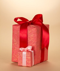 Obraz premium Big and little box, with gifts, decorated with bow, on beige