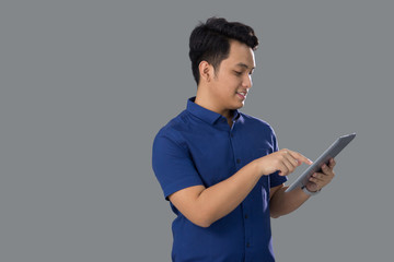 Asian Young Man in Casual using tablet