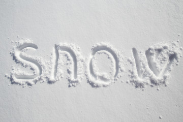 Handwritten inscription on pure white snowdrift - snow.