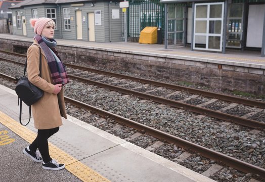 Woman waiting for train in railway station