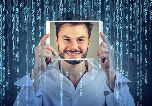 Happy man holding tablet with his face displayed on a screen isolated on binary code background  - Powered by Adobe