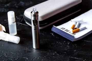 elimination of tobacco smoking electronic cigarette on dark back