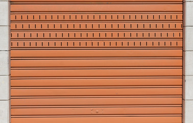 Orange security shutters outside a store
