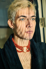 Handsome guy model bissexual with beads around his neck