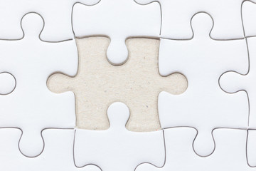 close up of White jigsaw puzzle with missed piece