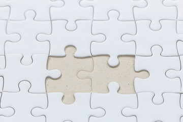 Fototapeta premium close up of White jigsaw puzzle with missed piece