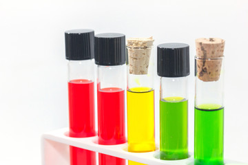 close up of colorful liquid in test tubes on rack
