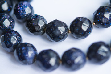 Blurred abstract art closeup with selective focus of beautiful attractive shiny beads in a fashion and handicraft accessory concept. Different elegant handmade jewellery gem necklace background