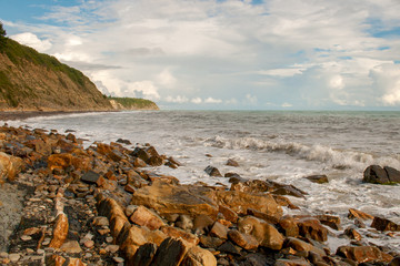 The rocky shore of the black sea. Steep slope. waves on the sea