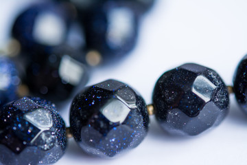 Blurred abstract art closeup with selective focus of beautiful attractive shiny beads in a fashion and handicraft accessory concept. Different elegant handmade jewellery gem necklace background